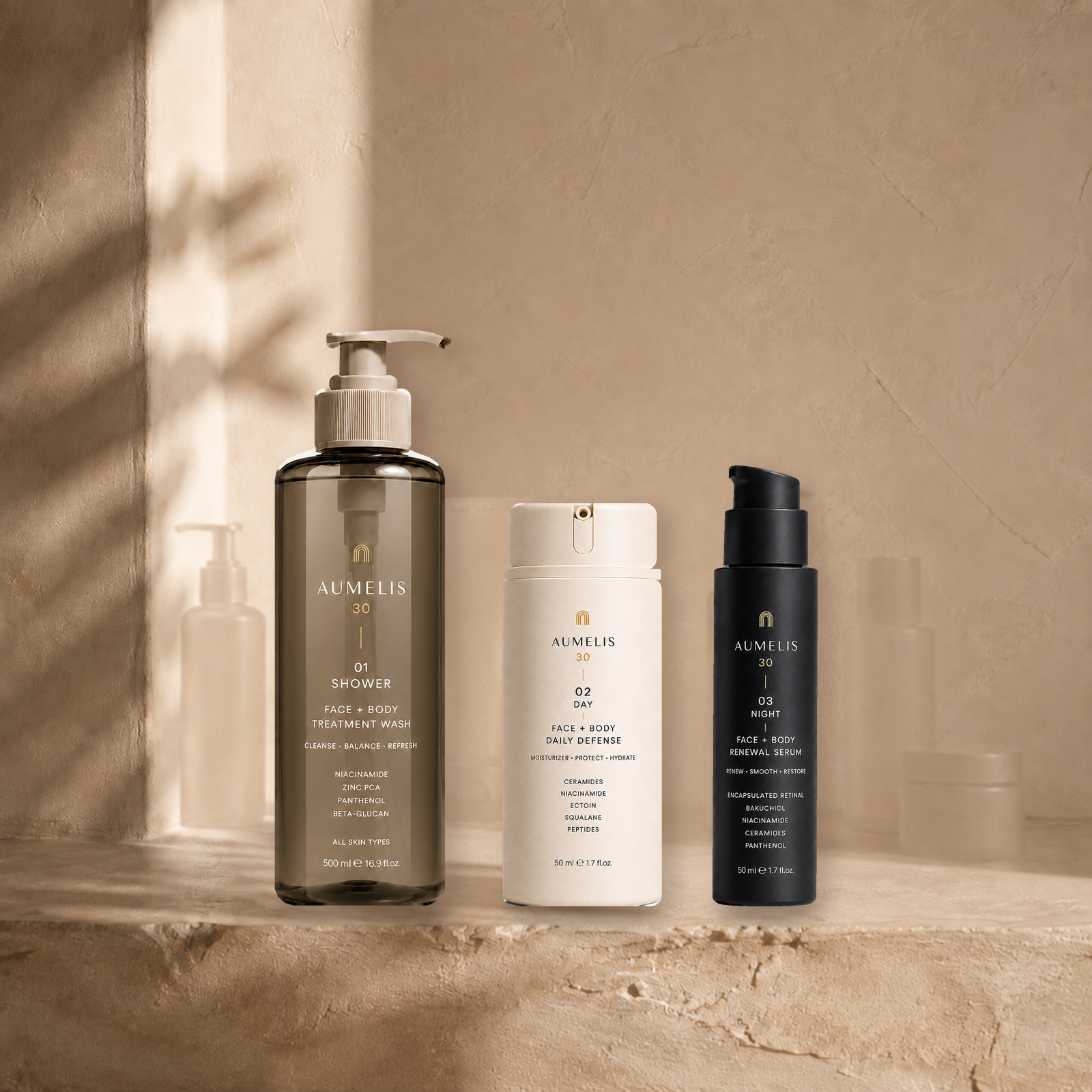 The three AUMELIS 30 bottles on a travertine ledge in soft light